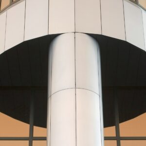 a large metal pole in front of a building